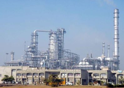 Refinery in India with blue sky and metal pipes in the background