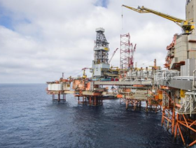 Oil up on deeper production cuts, trade news